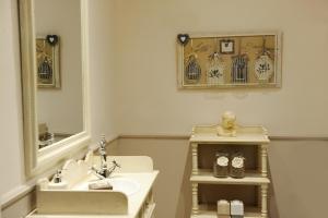 a bathroom with a sink and a mirror at La Garçonniere-Suite in Salerno centro in Salerno