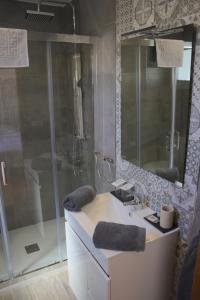 a bathroom with a sink and a shower with a mirror at Hostal Don Peque Adult Recommended in Nerja