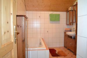 a bathroom with a tub and a sink at Ferienwohnung Zauner in Hallstatt +43 photos