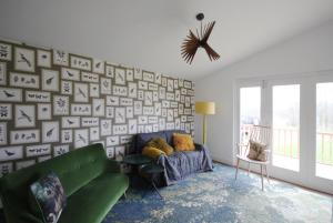 a living room with a green couch in front of a wall at Brook Meadow in Market Harborough