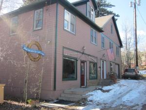 a pink house with a sign on the side of it at Dodgeton Creek Inn in Cuchara