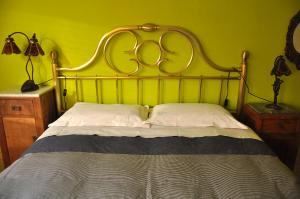 ペルージャにあるConcordiaのベッドルーム1室(大型ベッド1台、金のヘッドボード付)
