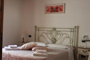 a bedroom with a bed with two towels on it at Alla Porta di Sopra in Castiglione dʼOrcia