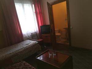 Habitación de hotel con cama y espejo en Садиба Достаток, en Kolomyia