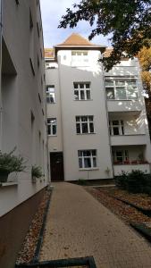 uma rua vazia em frente a um edifício branco em Apartament w Starej Kamienicy em Poznań