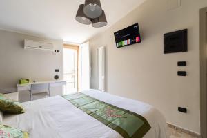 a bedroom with a bed and a tv on the wall at B&B San Carlo in Lamezia Terme