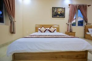 Katil atau katil-katil dalam bilik di Ven Song Riverside Hotel