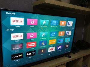 a television screen with a bunch of apps on it at Manila Bay Breeze Residences near MOA and NAIA in Manila
