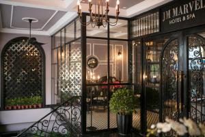 a building with a wrought iron gate and a restaurant at JM Marvel Hotel & Spa in Hanoi