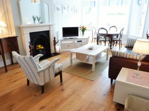 a living room with a couch and a table at Little Grosvenor in Ventnor