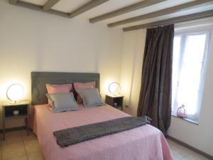 a bedroom with a large bed with two lamps at Le Grand Coudreau in Nazelles +22 photos