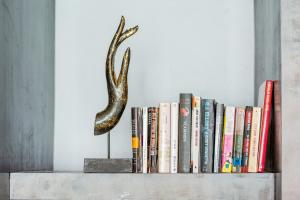 a book shelf with books and a snake on it at Enjoy Beach in Bophut