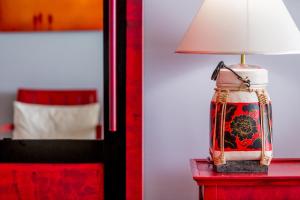 a lamp sitting on a table next to a bed at Enjoy Beach in Bophut