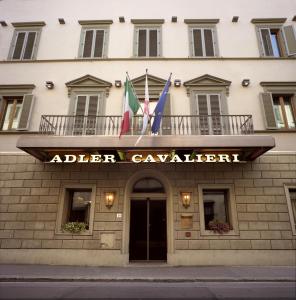 a building with flags on top of it at Adler Cavalieri Hotel-Private Spa & Gym in Florence