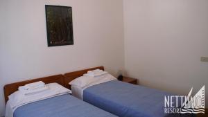 Postel nebo postele na pokoji v ubytování Nettuno Resort