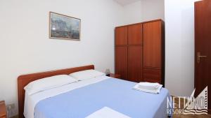 Postel nebo postele na pokoji v ubytování Nettuno Resort + 32 fotografií