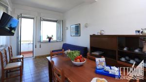 a living room with a table with a bowl of fruit on it at Nettuno Resort in Capo dʼOrlando