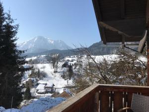 a view of a snow covered mountain from a deck at Reitbauernhof Schartner in Altaussee