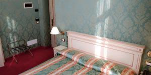 Postel nebo postele na pokoji v ubytování Hotel Villa Delle Palme