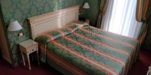 Postel nebo postele na pokoji v ubytování Hotel Villa Delle Palme