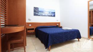Postel nebo postele na pokoji v ubytování Nettuno Resort