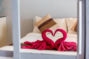 two pink flamingos sitting on top of a bed at Enjoy Beach in Bophut