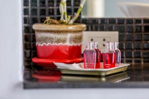 a table with a vase and two glass bottles at Enjoy Beach in Bophut