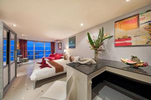 a bedroom with a bed and a living room at Enjoy Beach in Bophut