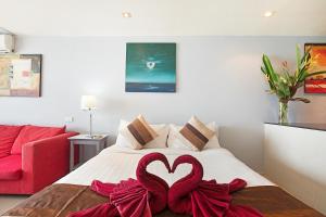 a bedroom with a bed with two red hearts on it at Enjoy Beach in Bophut