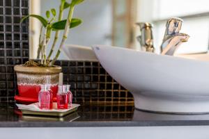 a bathroom counter with a sink and a potted plant at Enjoy Beach in Bophut