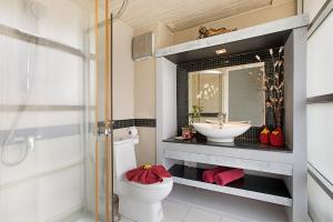 a bathroom with a sink and a toilet and a mirror at Enjoy Beach in Bophut