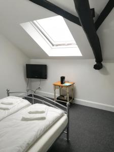 a bedroom with two beds and a skylight at Royal Guest House II in Viersen