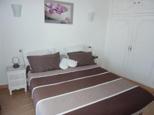 a bedroom with a large bed with brown and white at Le Tanagra in Vallauris