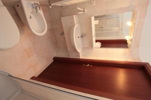 a bathroom with a sink and a toilet and a mirror at Appartamenti Il Borgo in Rivotorto