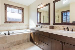 a bathroom with two sinks and a large mirror at Gray Bear 454 in Mammoth Lakes +23 photos