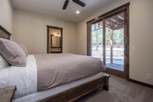 a bedroom with a bed and a large window at Gray Bear 454 in Mammoth Lakes