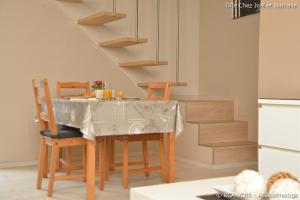 une cuisine avec une table et des chaises ainsi qu'un escalier dans l'établissement Gite Joël et Nathalie, à Urschenheim