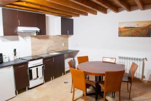 a kitchen with a table and chairs in a room at Casa De Campo De Oliveiras in Penela