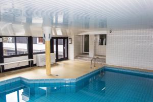 a large swimming pool in a building with a pool at Snow in Winterberg
