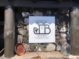 a sign for an abc bar on a stone wall at Adega JB in São Mateus