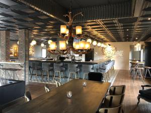 a restaurant with tables and chairs and a chandelier at Sideways Inn in Buellton