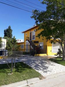 a yellow building with a playground in front of it at Amien Patagonia in Puerto Madryn