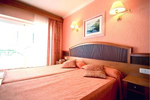 Łóżko lub łóżka w pokoju w obiekcie Hotel Manaus