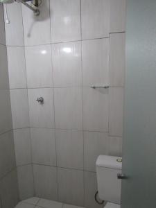 a white bathroom with a toilet and a shower at Hotel Moraes a 10 minutos da 25 de Março,Brás,Bom Retiro,a 2 minutos do Mirante Sampa Sky e pista de Skate Anhangabaú in Sao Paulo