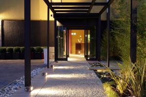 a hallway of a building with lights on the sidewalk at Hotel San Francesco in Borgomanero