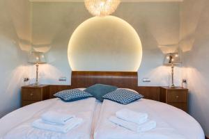 una camera da letto con un letto bianco con due asciugamani di Apartamenty Cicha Woda a Zakopane