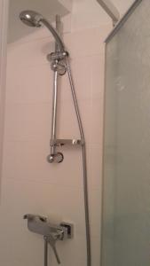 a shower with a shower head in a bathroom at Sète - vue mer imprenable, piscine, calme in Sète +28 photos