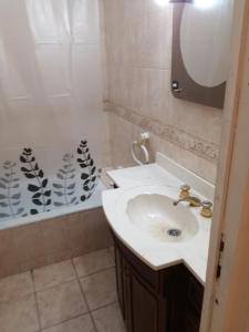 a bathroom with a sink and a bath tub at MA457 in Mendoza