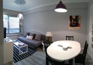 a living room with a table and a couch at Torre Center in Santiago de Compostela