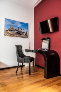 um quarto com uma secretária, uma cadeira e um piano em Culture Hotel Centro Storico em Nápoles